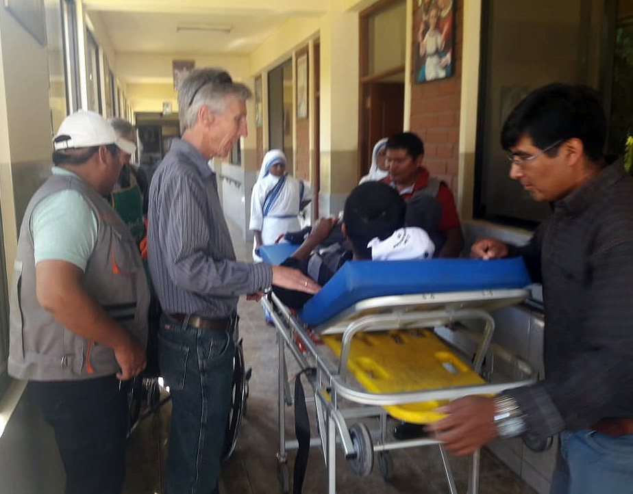 After almost a year in the hospital, Francisco Ayala arrives at the Missionaries of Charity Center in Cochabamba. Joe Loney is to the left of the stretcher.