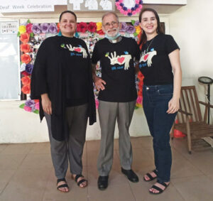 Maryknoll Lay Missioners Julie, Fr. Charlie and Kylene pose for a photo