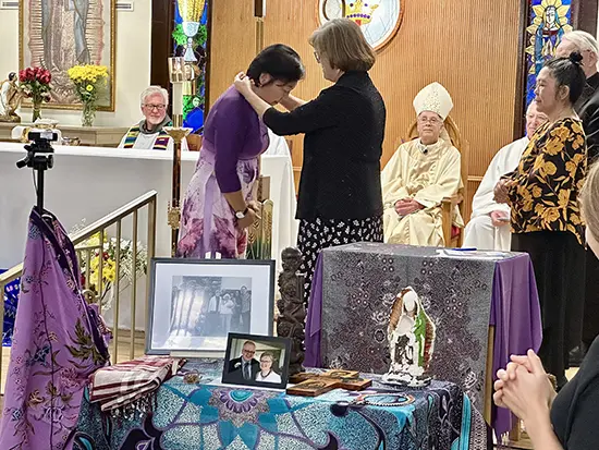 T.T. Hoang receives her mission cross