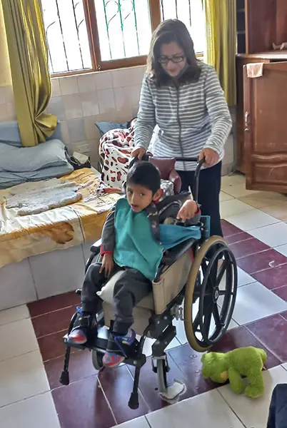 Filo pushing Juan Arturo's wheelchair 