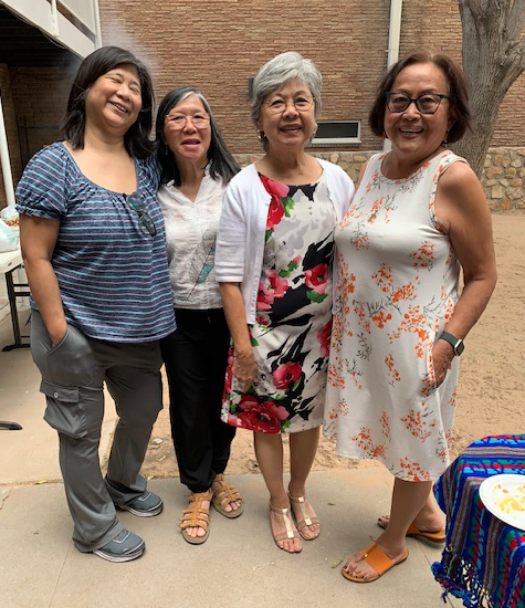 4 women stand together.