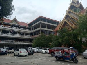 An image of a multi-story building taken from a parking lot.